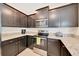 Kitchen featuring dark wood cabinets, granite countertops, and modern stainless steel appliances at 6318 Sw 89Th Lane Rd, Ocala, FL 34476