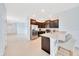 Modern kitchen featuring stainless steel appliances, granite countertops, and breakfast bar seating at 6318 Sw 89Th Lane Rd, Ocala, FL 34476