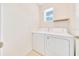 Efficient laundry room with a side by side washer and dryer and natural light at 6318 Sw 89Th Lane Rd, Ocala, FL 34476