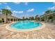 Bright community pool featuring a tanning shelf and lounge chairs under wood pergolas at 6318 Sw 89Th Lane Rd, Ocala, FL 34476