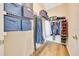 Organized walk-in closet with shelving, hanging rods, and laminate flooring at 6318 Sw 89Th Lane Rd, Ocala, FL 34476