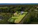Aerial view showing the property's full landscape, mature trees, home, and proximity to the road at 6497 W Anthony Rd, Ocala, FL 34479
