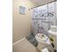 This full bathroom showcases a decorated toilet and shower with themed curtain at 6497 W Anthony Rd, Ocala, FL 34479
