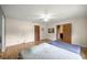 Bedroom showcasing natural light, wood-look flooring, and open doorway to another room at 6497 W Anthony Rd, Ocala, FL 34479