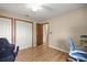 Bedroom featuring two closets, vinyl floors, and blue and black gaming chairs at 6497 W Anthony Rd, Ocala, FL 34479