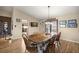 Cozy dining room featuring a wood table with chairs, decorative lighting, and views into the kitchen at 6497 W Anthony Rd, Ocala, FL 34479
