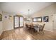 Bright dining room featuring wood floors, elegant lighting, and French doors leading to outdoor space, perfect for gatherings at 6497 W Anthony Rd, Ocala, FL 34479
