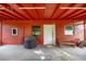 Covered outdoor space featuring an orange ceiling, a small bench, a grill, and access to a door for convenient access at 6497 W Anthony Rd, Ocala, FL 34479