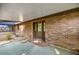 Covered patio featuring brick walls, a concrete floor, and a view into the screened porch and backyard at 6497 W Anthony Rd, Ocala, FL 34479
