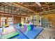 Spacious garage features high ceilings, exposed rafters, storage, and a dedicated gymnastic workout area at 6497 W Anthony Rd, Ocala, FL 34479