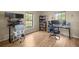 This home office features natural light, wood floors, and dual monitor setups at 6497 W Anthony Rd, Ocala, FL 34479