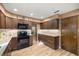 Stylish kitchen with granite countertops, wood cabinets, and stainless steel appliances, perfect for cooking and entertaining at 6497 W Anthony Rd, Ocala, FL 34479