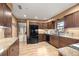 Well-appointed kitchen boasting granite countertops, dark wood cabinetry, and modern appliances for a chef-inspired experience at 6497 W Anthony Rd, Ocala, FL 34479