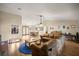 Open-concept living area with a cozy seating arrangement, wood floors, fireplace, and seamless flow to dining area at 6497 W Anthony Rd, Ocala, FL 34479