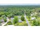 Drone shot of residential area featuring homes surrounded by trees and roads at 6511 Se 25Th Ave, Ocala, FL 34480