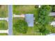 Birds-eye view of a home with well-maintained lawn, driveway and mature trees surrounding the property at 6511 Se 25Th Ave, Ocala, FL 34480