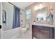 Bathroom featuring a shower-tub combo and a granite vanity at 6511 Se 25Th Ave, Ocala, FL 34480