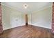Bedroom with wood floors, double closet space, and adjacent access to hallway at 6511 Se 25Th Ave, Ocala, FL 34480