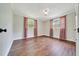 Bedroom with two windows and wood floors, providing ample natural light and space at 6511 Se 25Th Ave, Ocala, FL 34480