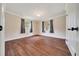 Bedroom with wood floors and two windows, providing ample natural light and space at 6511 Se 25Th Ave, Ocala, FL 34480