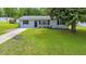 Charming single-story home with a well-maintained front yard and a concrete driveway at 6511 Se 25Th Ave, Ocala, FL 34480