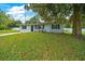 Beautiful home showcasing a spacious yard, mature trees, and fresh landscaping at 6511 Se 25Th Ave, Ocala, FL 34480