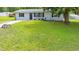 Charming home with a well-manicured lawn, inviting entrance and blooming window box at 6511 Se 25Th Ave, Ocala, FL 34480