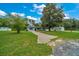 Lovely home with a spacious yard, a concrete driveway, and mature trees at 6511 Se 25Th Ave, Ocala, FL 34480