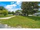 Home with spacious yard, mature trees, concrete driveway, and a well-maintained lawn at 6511 Se 25Th Ave, Ocala, FL 34480