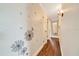 Hallway with decorative wall art and neutral wall tone; access to other rooms in home at 6511 Se 25Th Ave, Ocala, FL 34480