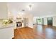 Open-concept kitchen with stainless steel appliances and wood flooring at 6511 Se 25Th Ave, Ocala, FL 34480