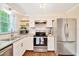 Kitchen with stainless steel appliances, granite countertops and open shelving at 6511 Se 25Th Ave, Ocala, FL 34480