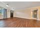 View of bright living room, hardwood floors, neutral paint, ceiling fan and door at 6511 Se 25Th Ave, Ocala, FL 34480
