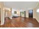 Living room featuring dark wood-look floors, neutral walls and trim, and a ceiling fan at 6511 Se 25Th Ave, Ocala, FL 34480