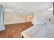 Open-concept living room with hardwood floors, ceiling fan, and neutral decor at 6511 Se 25Th Ave, Ocala, FL 34480