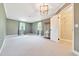 Spacious main bedroom featuring neutral colors, carpeted floors, and an ensuite bathroom at 6511 Se 25Th Ave, Ocala, FL 34480