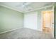 This light and airy bedroom offers soft carpeting, neutral paint and a closet for storage at 6877 Minchew Cir, The Villages, FL 34762