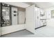Epoxy floor, white cabinets, and door to HVAC system featured in this home's garage at 6877 Minchew Cir, The Villages, FL 34762