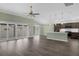 Living room with open floor plan, sliding glass doors to the patio, and kitchen with island at 6877 Minchew Cir, The Villages, FL 34762