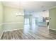 Open floor plan with living room, dining area, and kitchen with access to the patio at 6877 Minchew Cir, The Villages, FL 34762