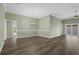 Open concept living room with dining area, hardwood floors, and neutral paint at 6877 Minchew Cir, The Villages, FL 34762