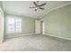 Spacious main bedroom with vaulted ceilings, a ceiling fan, neutral walls, and carpeted floors at 6877 Minchew Cir, The Villages, FL 34762
