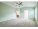 Spacious main bedroom with a ceiling fan, a bathroom, and a walk-in closet at 6877 Minchew Cir, The Villages, FL 34762
