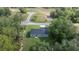 A scenic aerial view of a cozy home on a lush lot, surrounded by trees and green landscape at 75 Guava Ter, Ocklawaha, FL 32179