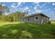 The spacious backyard features lush green grass perfect for outdoor activities and relaxation at 75 Guava Ter, Ocklawaha, FL 32179