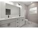 Modern bathroom with double vanity, quartz countertops, and a tiled shower at 75 Guava Ter, Ocklawaha, FL 32179