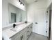 Modern bathroom featuring dual sinks, quartz countertops, and sleek black fixtures at 75 Guava Ter, Ocklawaha, FL 32179