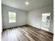 A cozy bedroom with a modern bathroom featuring white cabinets and luxury countertops at 75 Guava Ter, Ocklawaha, FL 32179