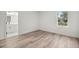 Bedroom with wood-look floors and a large window at 75 Guava Ter, Ocklawaha, FL 32179