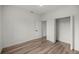 Bedroom with wood-look floors, a walk-in closet, and an additional closet at 75 Guava Ter, Ocklawaha, FL 32179